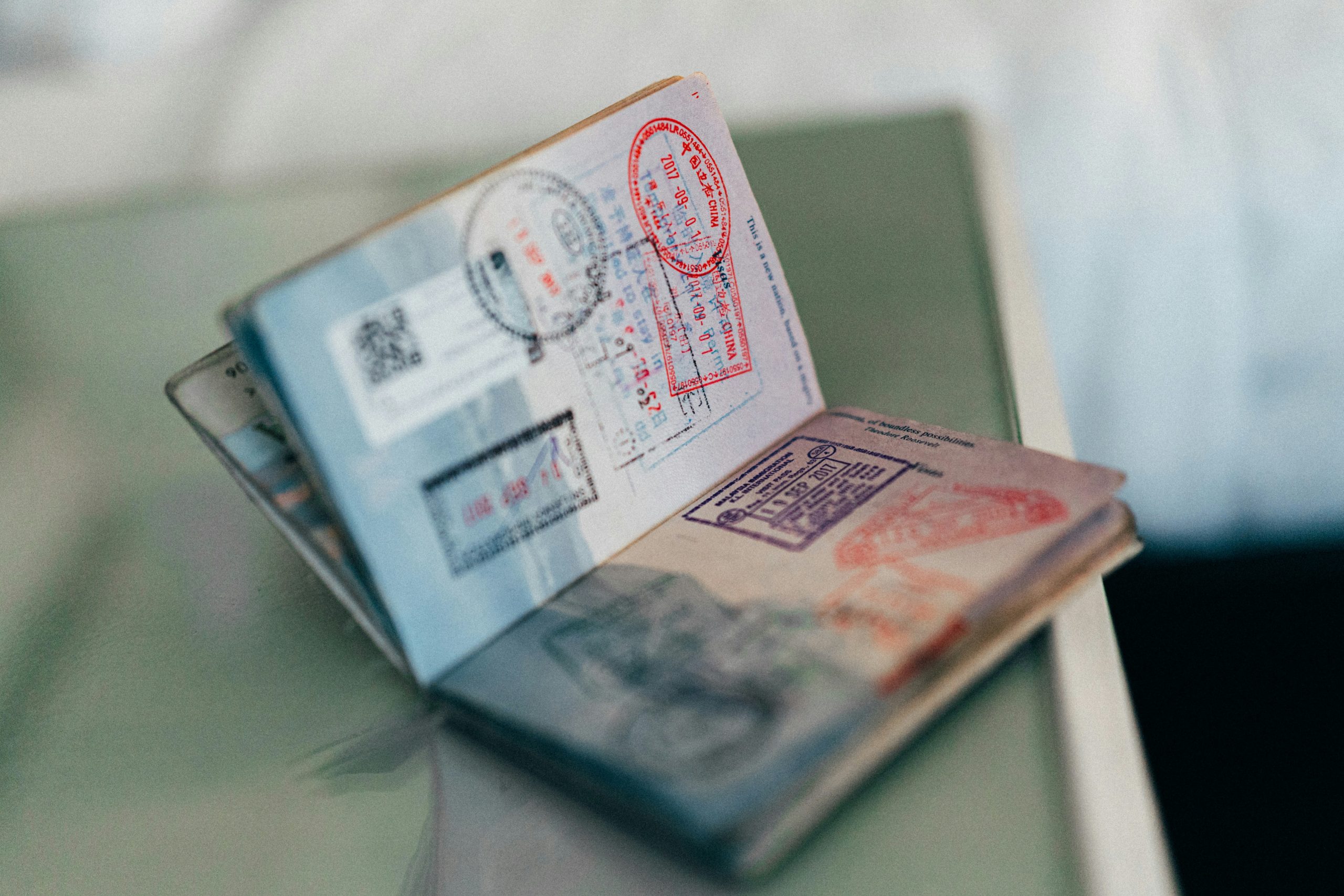 An open passport with entry stamps, the only stand-alone document the IRS accepts for an ITIN application